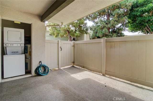 8566 Van Ness Ct Unit 21D, Huntington Beach, CA 92646 - view of patio featuring stacked washer / dryer and a gate