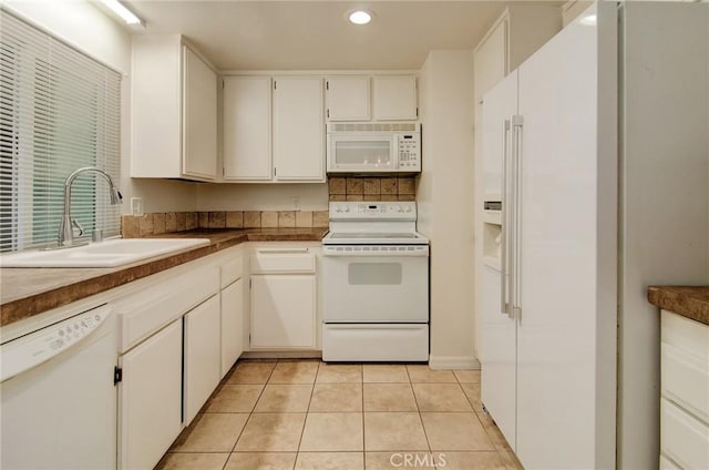 8566 Van Ness Ct Unit 21D, Huntington Beach, CA 92646 - kitchen with white appliances, a sink, light tile patterned floors, white cabinetry, and recessed lighting