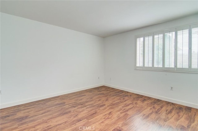 8566 Van Ness Ct Unit 21D, Huntington Beach, CA 92646 - unfurnished room featuring baseboards and wood finished floors