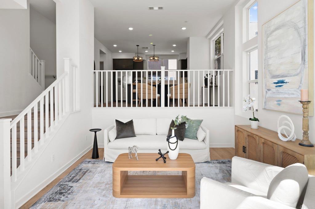 10472 San Diego Mission Rd Unit 11, San Diego, CA 92108 - living room with wood finished floors, stairs, and recessed lighting