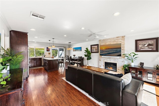 22665 Ancona, Laguna Hills, CA 92653 - living room with recessed lighting, ornamental molding, visible vents, and a fireplace