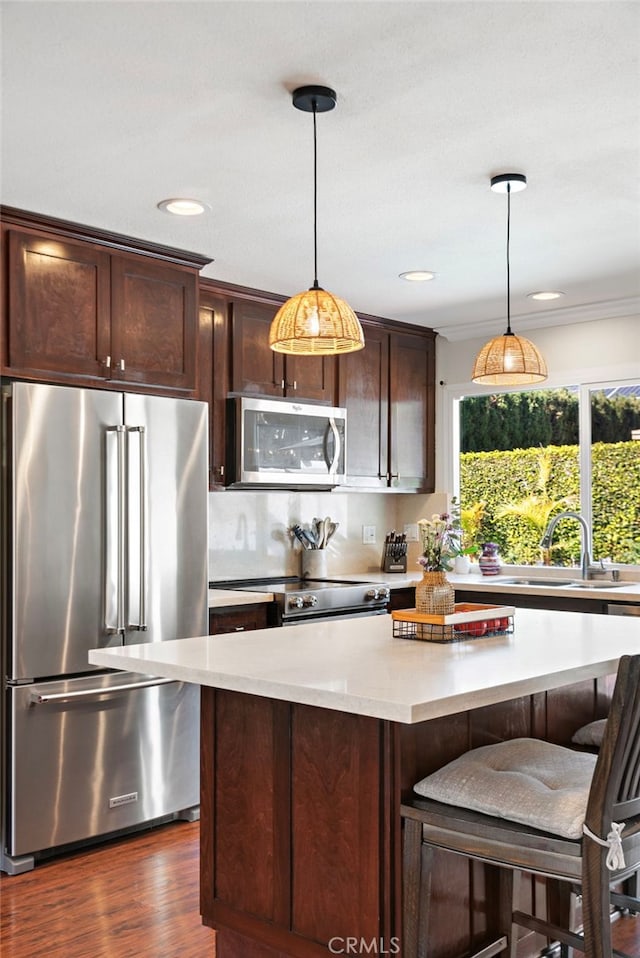 22665 Ancona, Laguna Hills, CA 92653 - kitchen with light countertops, dark brown cabinets, a sink, a kitchen island, and appliances with stainless steel finishes
