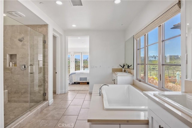 ensuite bathroom with visible vents, two vanities, a sink, and a stall shower