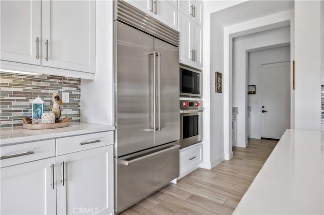 116 Via Bilbao, San Clemente, CA 92672 - kitchen featuring built in appliances, white cabinets, and light countertops