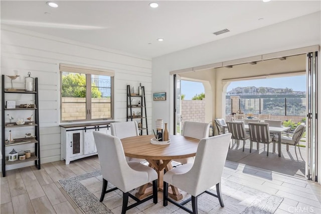 dining space featuring visible vents, recessed lighting, a wealth of natural light, and light wood-type flooring