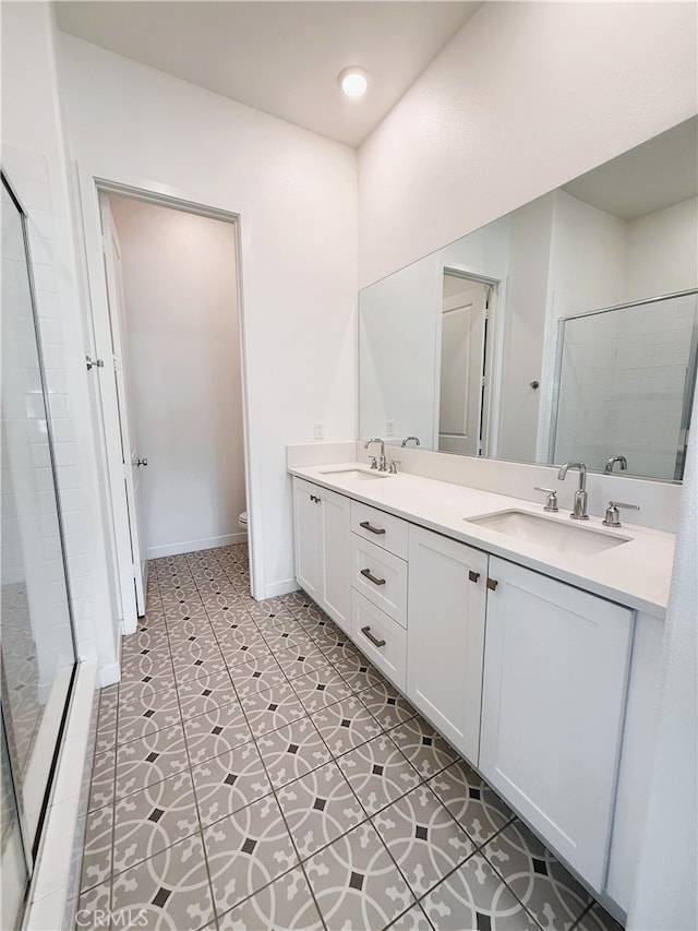 27078 Painted Sky Way, Valencia, CA 91381 - bathroom with a shower stall, toilet, double vanity, and tile patterned floors
