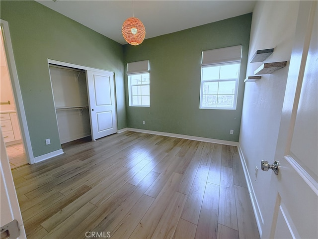 27078 Painted Sky Way, Valencia, CA 91381 - unfurnished bedroom featuring light wood-style floors, a closet, and baseboards