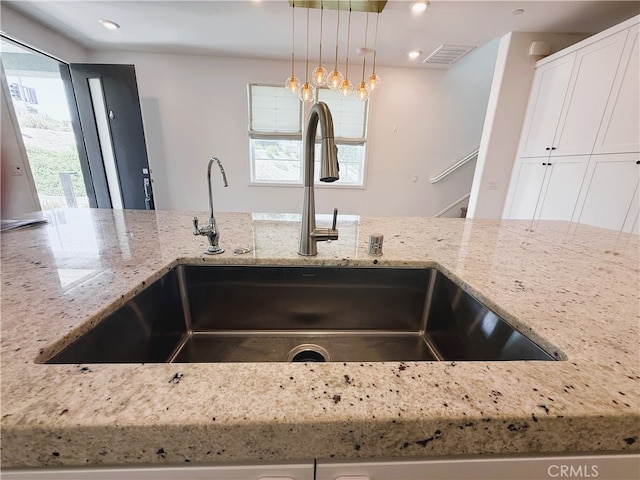 27078 Painted Sky Way, Valencia, CA 91381 - kitchen view of a sink, light stone counters, white cabinetry, decorative light fixtures, and recessed lighting