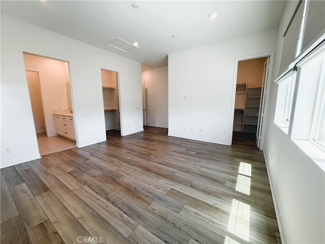 27078 Painted Sky Way, Valencia, CA 91381 - unfurnished bedroom featuring a walk in closet, a closet, wood finished floors, baseboards, and recessed lighting