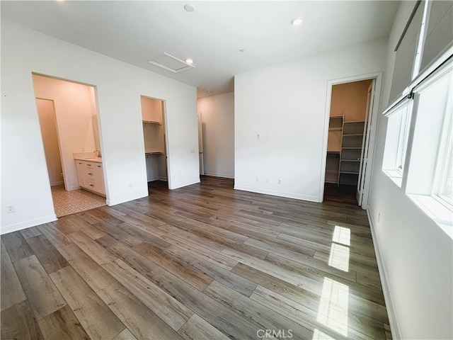 27078 Painted Sky Way, Valencia, CA 91381 - unfurnished bedroom with a spacious closet, a closet, wood finished floors, ensuite bathroom, and recessed lighting