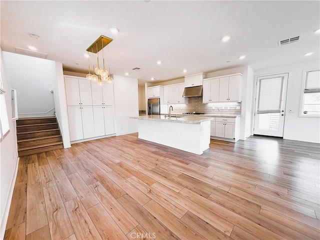 27078 Painted Sky Way, Valencia, CA 91381 - kitchen with stainless steel fridge with ice dispenser, under cabinet range hood, a sink, light wood-style flooring, and recessed lighting