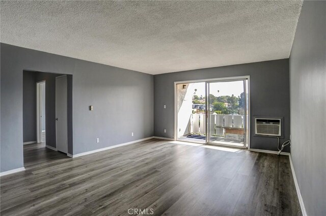4343 Finley Ave Unit 35, Los Angeles, CA 90027 - spare room with dark wood-type flooring, a wall mounted air conditioner, and a textured ceiling