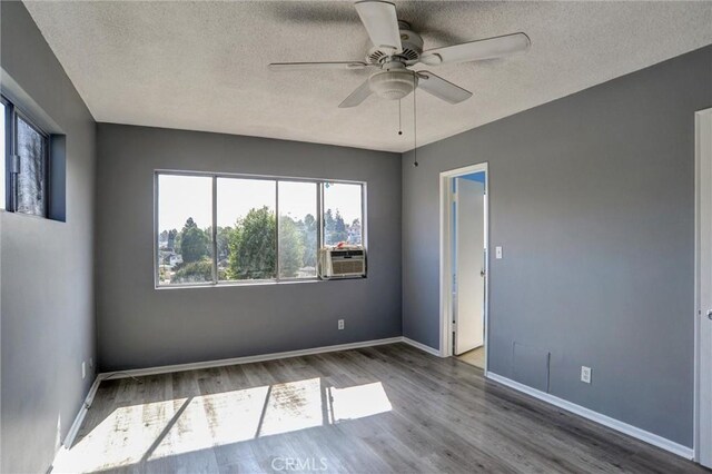 4343 Finley Ave Unit 35, Los Angeles, CA 90027 - unfurnished room featuring wood finished floors, ceiling fan, a textured ceiling, and cooling unit