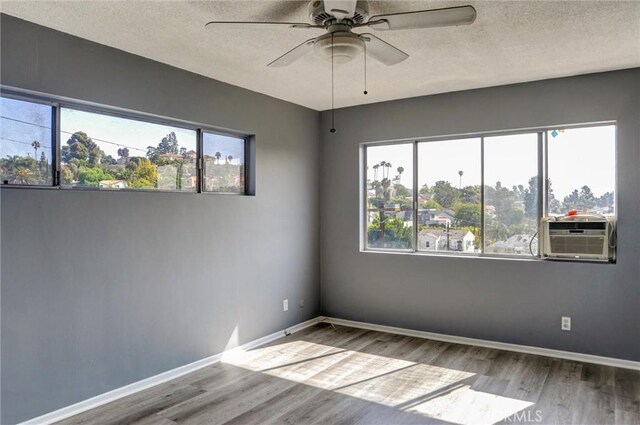 4343 Finley Ave Unit 35, Los Angeles, CA 90027 - unfurnished room with wood finished floors, a ceiling fan, a textured ceiling, and cooling unit