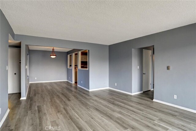 4343 Finley Ave Unit 35, Los Angeles, CA 90027 - unfurnished living room featuring wood finished floors and a textured ceiling