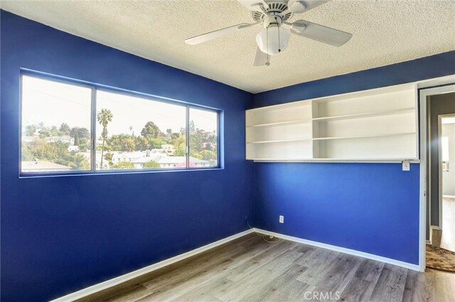 4343 Finley Ave Unit 35, Los Angeles, CA 90027 - unfurnished room featuring wood finished floors, a textured ceiling, and a ceiling fan