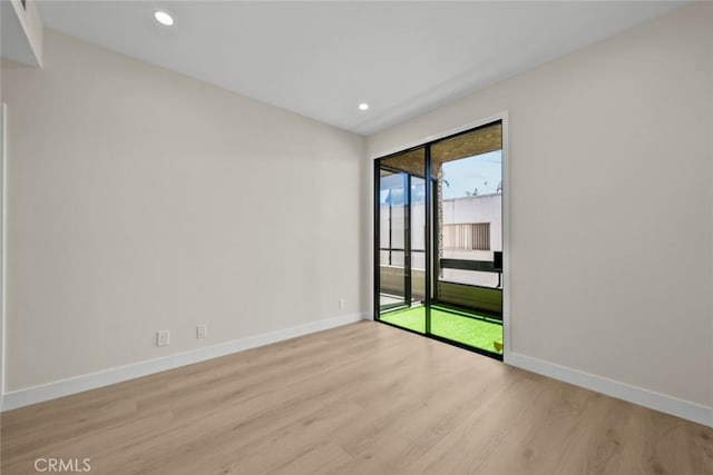 unfurnished room with baseboards, recessed lighting, and light wood-style floors