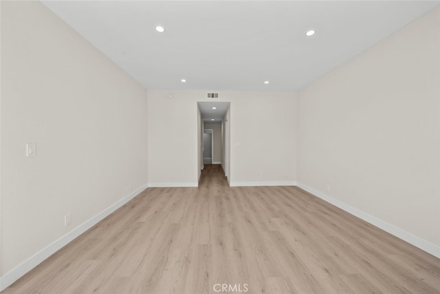spare room with baseboards, visible vents, light wood-style floors, and recessed lighting