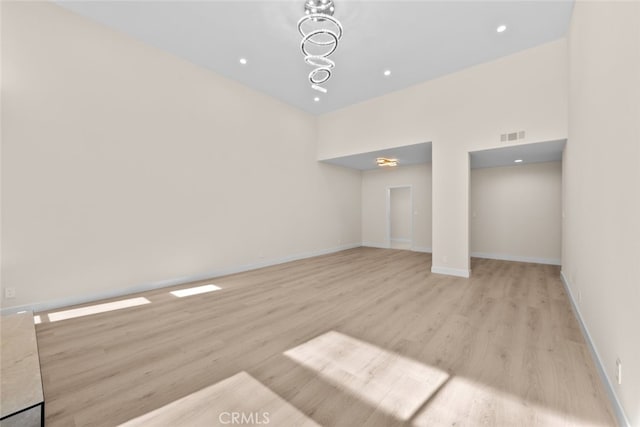 interior space featuring wood finished floors, recessed lighting, visible vents, and baseboards