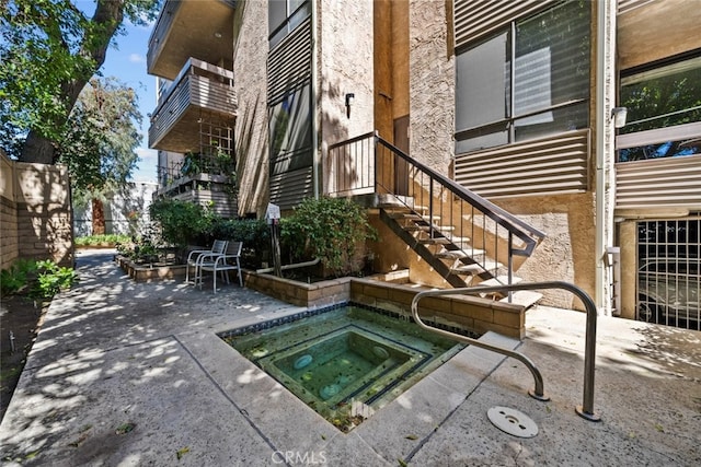 view of swimming pool with an in ground hot tub and a patio area