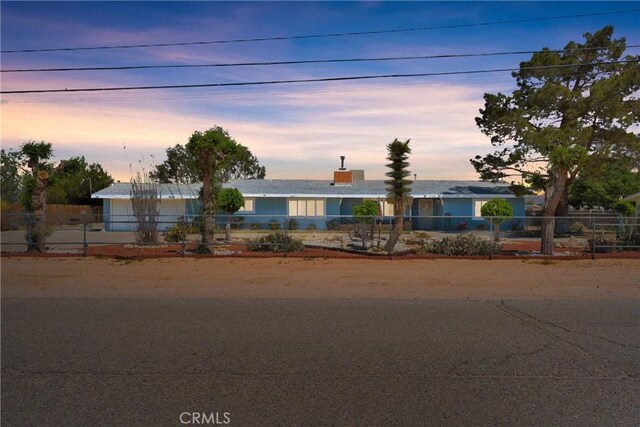 single story home featuring a fenced front yard