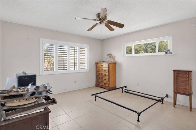 bedroom featuring ceiling fan and a textured ceiling