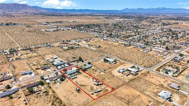 birds eye view of property with view of desert, a rural view, and a mountain view
