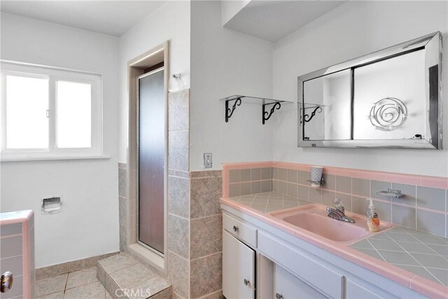 full bathroom with tile patterned floors, vanity, a shower stall, and tasteful backsplash