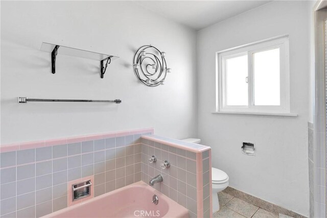 full bath featuring a bath, toilet, and tile patterned flooring