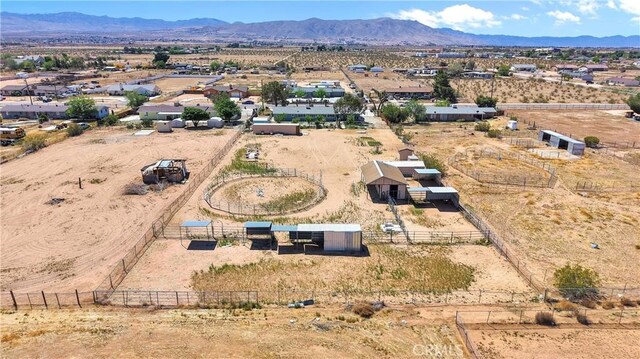 aerial view featuring a rural view, a desert view, and a mountain view