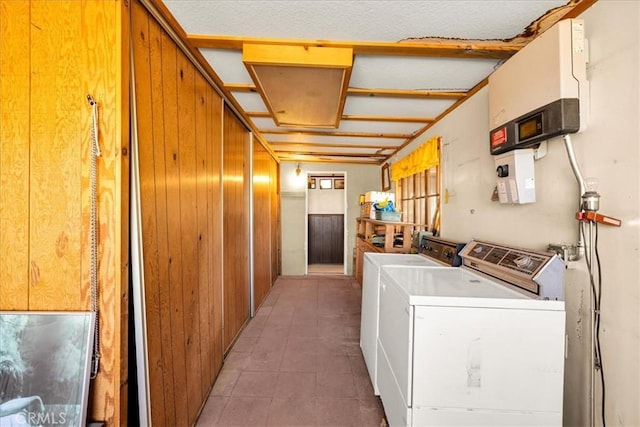 laundry room featuring independent washer and dryer, light tile patterned floors, and laundry area