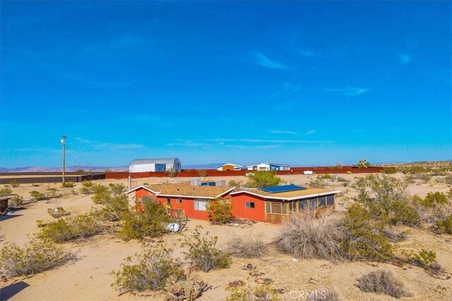 exterior space featuring a desert view and a mountain view
