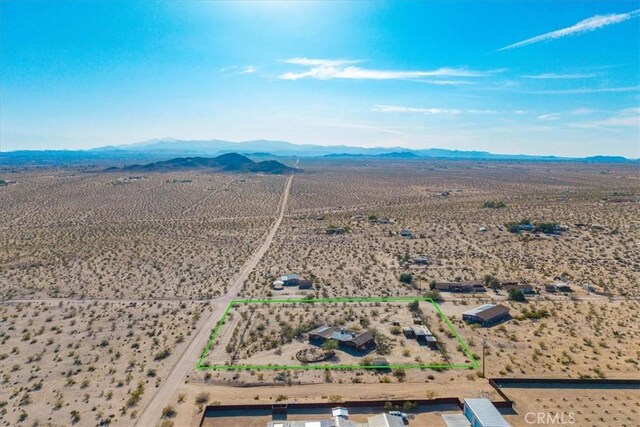 birds eye view of property with a mountain view, a desert view, and a rural view