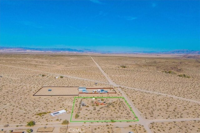 birds eye view of property with view of desert, a rural view, and a mountain view