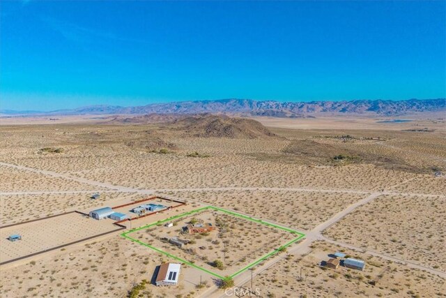bird's eye view featuring a rural view, a desert view, and a mountain view