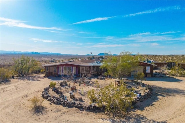 back of property with a mountain view