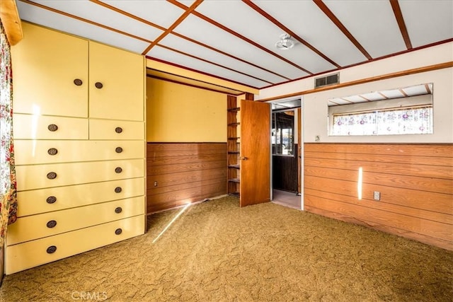 interior space with wooden walls and visible vents