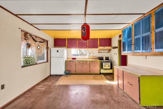 kitchen with range with gas cooktop, freestanding refrigerator, concrete flooring, light countertops, and under cabinet range hood