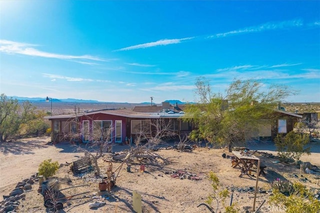 rear view of property featuring a mountain view