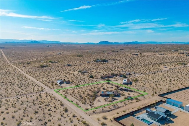 birds eye view of property with view of desert, a rural view, and a mountain view