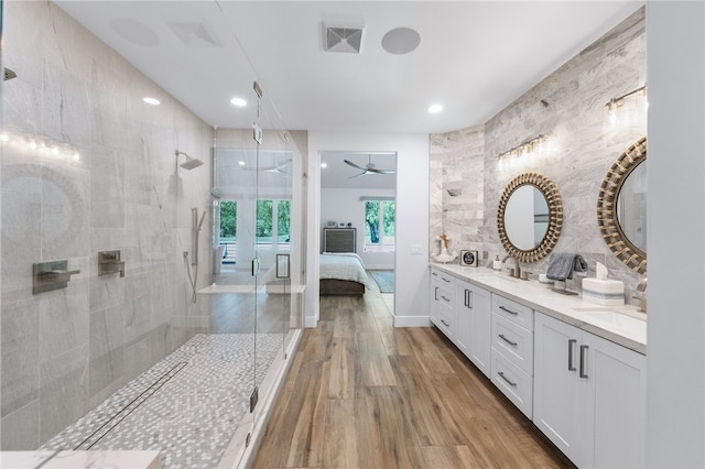 38101 Stone Meadow Dr, Murrieta, CA 92562 - full bath with double vanity, wood finished floors, a sink, tiled shower, and ensuite bathroom