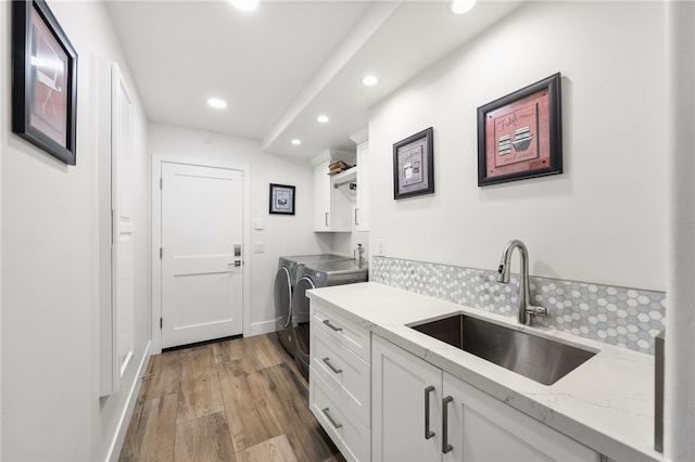 38101 Stone Meadow Dr, Murrieta, CA 92562 - kitchen featuring a sink, light wood finished floors, washing machine and dryer, white cabinetry, and recessed lighting