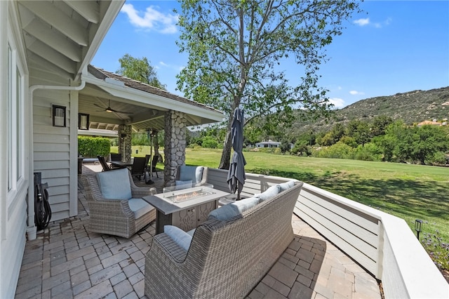 38101 Stone Meadow Dr, Murrieta, CA 92562 - view of patio / terrace with a fire pit, ceiling fan, and a mountain view