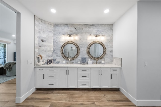38101 Stone Meadow Dr, Murrieta, CA 92562 - full bathroom with a sink, double vanity, decorative backsplash, wood finished floors, and ensuite bath