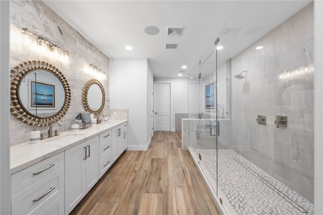 38101 Stone Meadow Dr, Murrieta, CA 92562 - full bathroom with wood finished floors, a sink, visible vents, and tiled shower