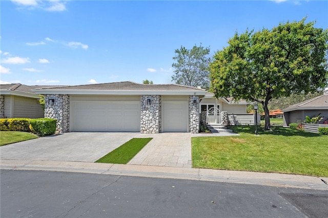 38101 Stone Meadow Dr, Murrieta, CA 92562 - view of front of property with an attached garage, stone siding, a front yard, and decorative driveway