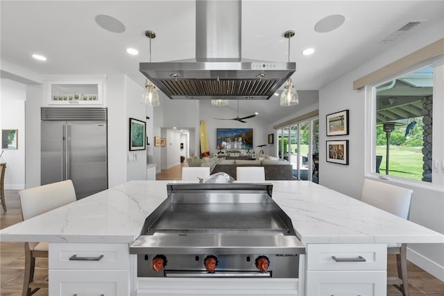 38101 Stone Meadow Dr, Murrieta, CA 92562 - kitchen featuring a kitchen bar, white cabinets, stainless steel built in refrigerator, and extractor fan