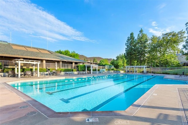 38101 Stone Meadow Dr, Murrieta, CA 92562 - pool with fence, a patio area, and a mountain view