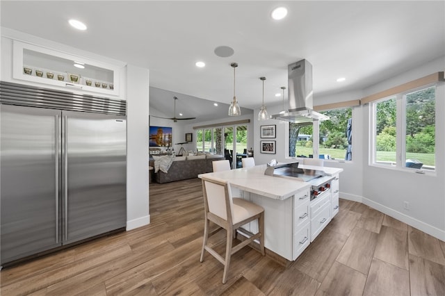38101 Stone Meadow Dr, Murrieta, CA 92562 - kitchen featuring white cabinets, recessed lighting, island range hood, stainless steel built in fridge, and stovetop