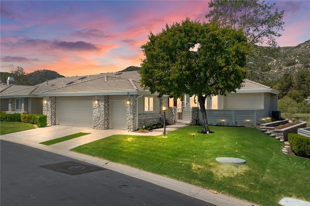 38101 Stone Meadow Dr, Murrieta, CA 92562 - view of front of property with a tiled roof, driveway, stone siding, a lawn, and a garage